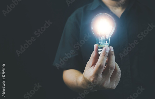 hand holding light bulb. idea concept with innovation and inspiration, ideas of new ideas with innovative technology and creativity. ideas creativity concept holding light bulb.