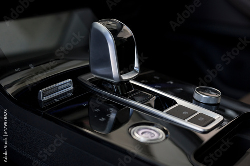 New unknown car with automatic transmission. Modern transportation. Close up. Themed blur background.