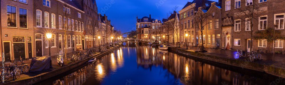 Panorama of the city embankment in Leiden at sunrise.