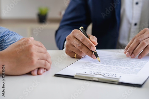 Real estate agents and clients are signing contracts and discussing home purchases, insurance or real estate loans.