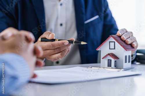 Real estate agents and clients are negotiating prices before signing and discussing home purchases, insurance or real estate loans. photo