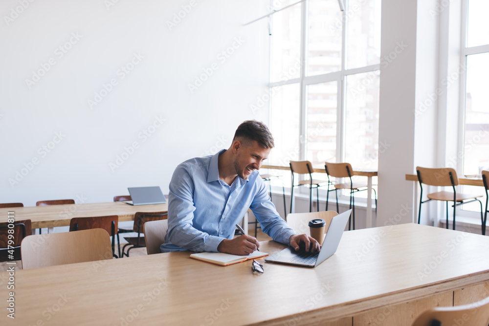 Skilled male student studying web design during distance e learning at table desktop using laptop computer for online research, happy Caucasian man connecting to wifi on netbook technology Skilled male student studying web design during distance e learning at table desktop using laptop computer for online research, happy Caucasian man connecting to wifi on netbook technology