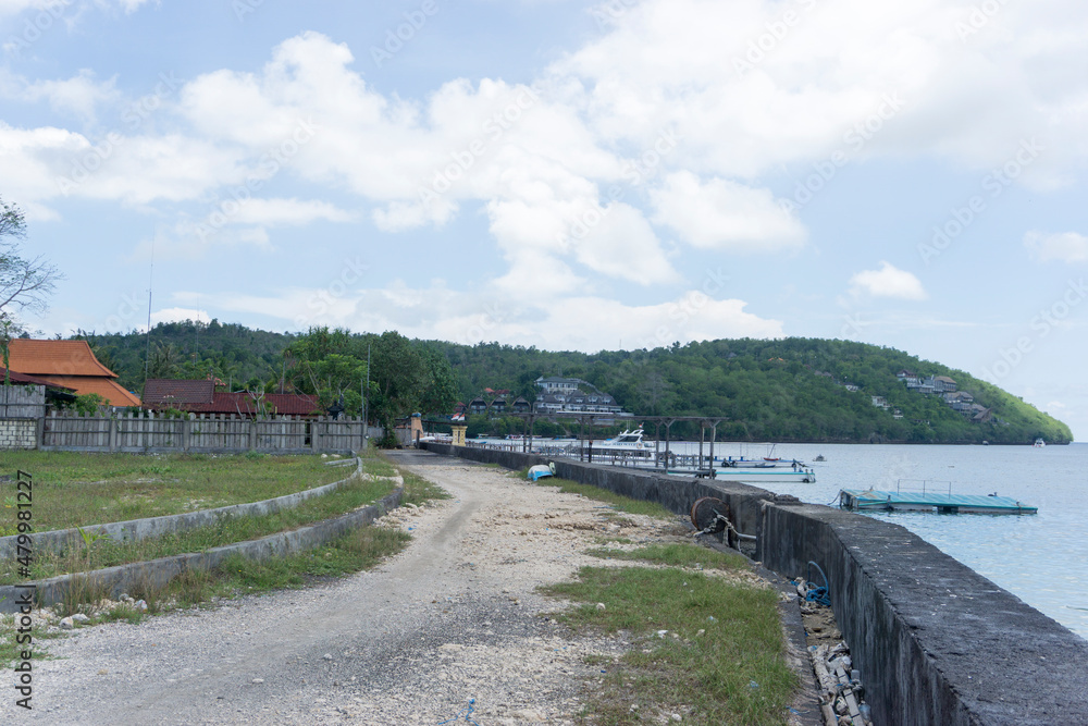 Village atmosphere in Nusa Penida Bali. Road by the sea.