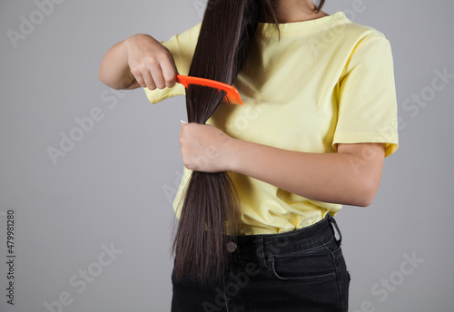 Woman combing her hair. Beautiful hair concept.