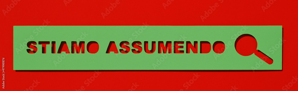 text we are hiring cut out on a green paper text we are hiring cut out on a green paper