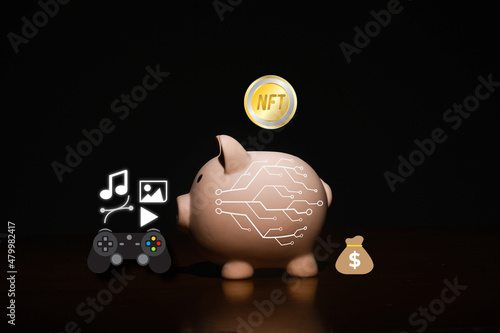 Fototapeta Naklejka Na Ścianę i Meble -  A picture of NFT token entering piggy bank with item that can sell in it. Create income with non fungible token and crypto art.
