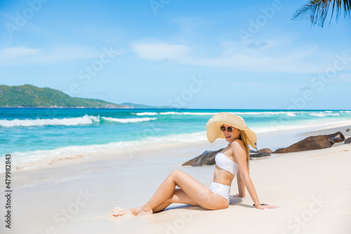Girl relax on the beach.White sand  blue cloudy sky and crystal sea of tropical beach. Vacation at Paradise. Ocean beach relax  travel to Maldives islands