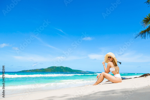 Relaxed bikini woman enjoying tropical beach and Seychelles summer vacation.
