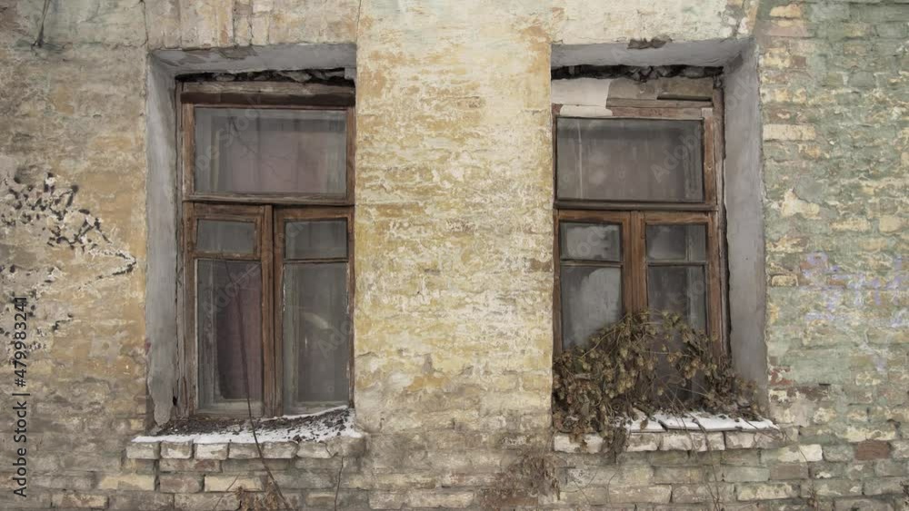 Two windows on the wall of an old abandoned 19th century brick house, textured. Two windows on the wall of an old abandoned 19th century brick house, textured.