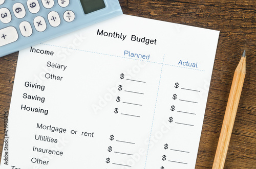 A print out of a monthly budget for your text with pencil and calculator photo