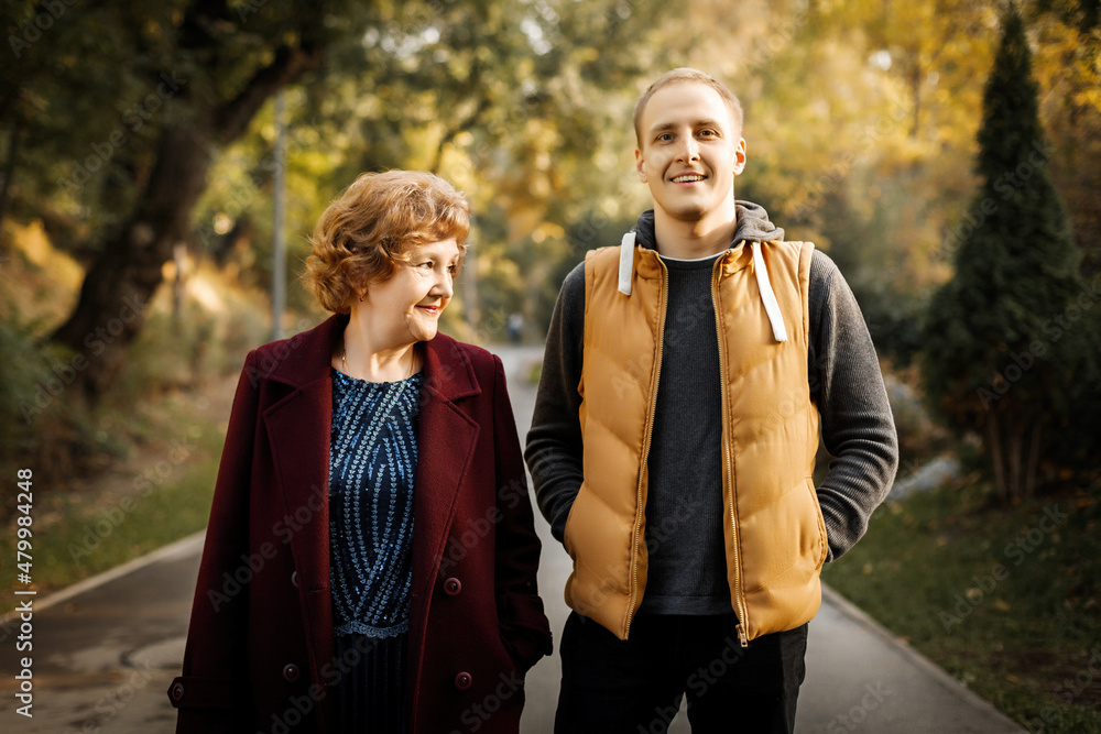 Russian caucasian mature mother with her adult son walking autumn outdoor. Russian caucasian mature mother with her adult son walking autumn outdoor.