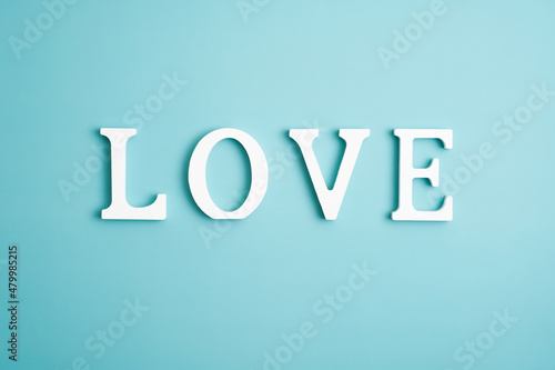 Word love on blue background. Happy Valentines Day concept. Minimal style.