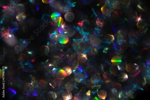 Abstract defocused black background with shining glitter.Good as overlay layer.