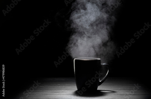 Steaming cup on black background.