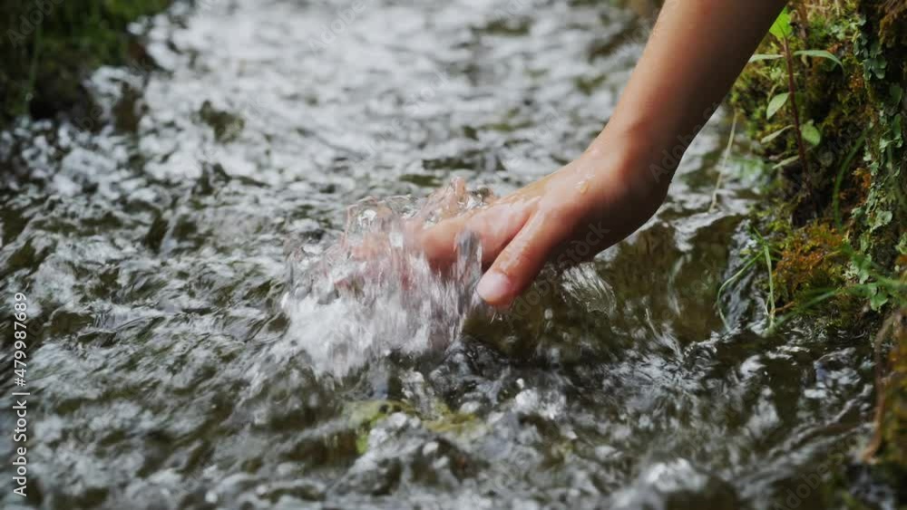 child hand touching water in nature. Water streaming in the river in forest. nature and life concept. fresh stream water child hand touching water in nature. Water streaming in the river in forest. nature and life concept. fresh stream water