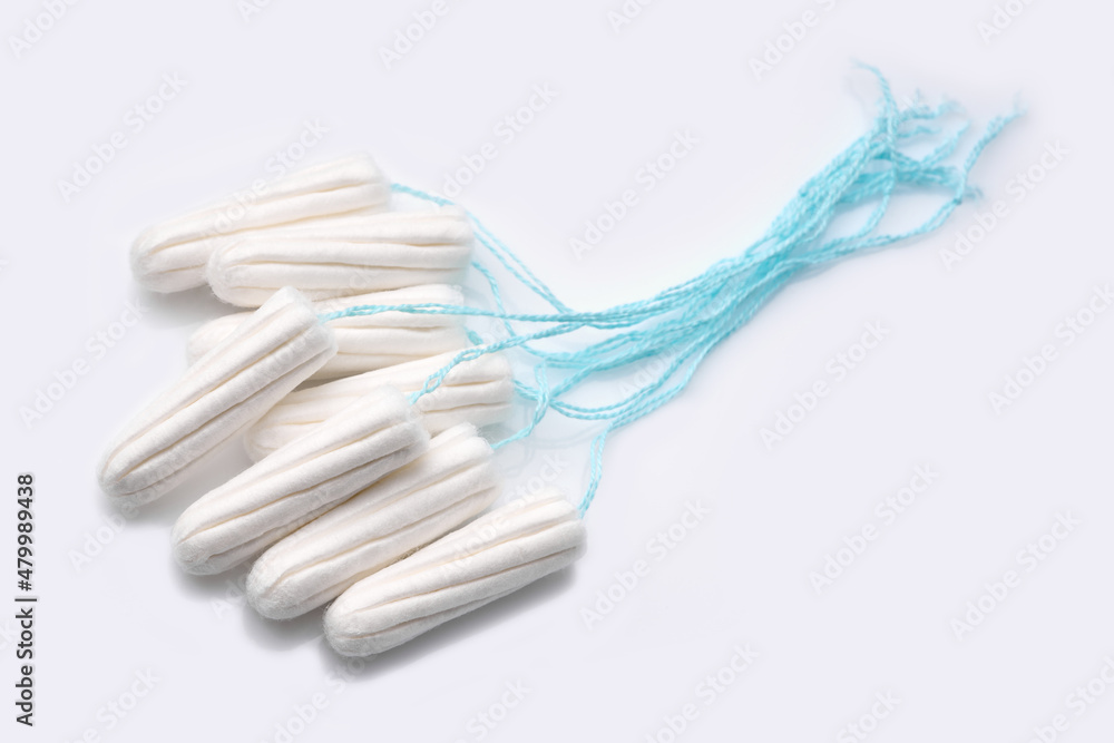 Medical female tampon on a pink background. Hygienic white tampon for women. Cotton swab. Menstruation, means of protection. Tampons on a red background. Medical female tampon on a pink background. Hygienic white tampon for women. Cotton swab. Menstruation, means of protection. Tampons on a red background.