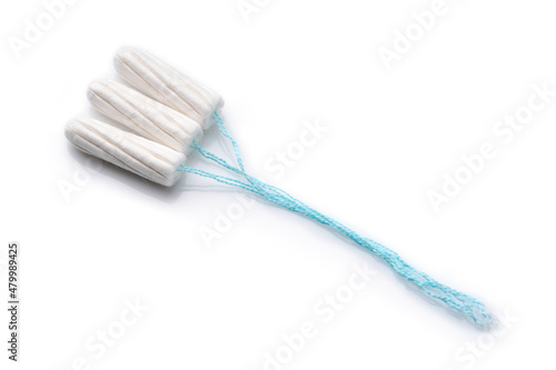 Medical female tampon on a pink background. Hygienic white tampon for women. Cotton swab. Menstruation  means of protection. Tampons on a red background.