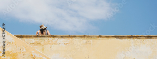 Wallpaper Mural Horizontal banner or header with back view of beautiful curvy woman with hat on historic building terrace at old town - Travel concept Torontodigital.ca