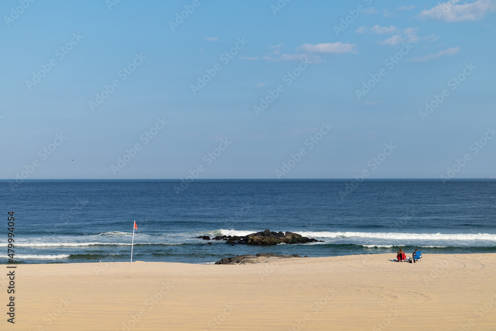 Shore of Long Branch Beach with a Couple Relaxing along the Atlantic Ocean in Long Branch New Jersey
