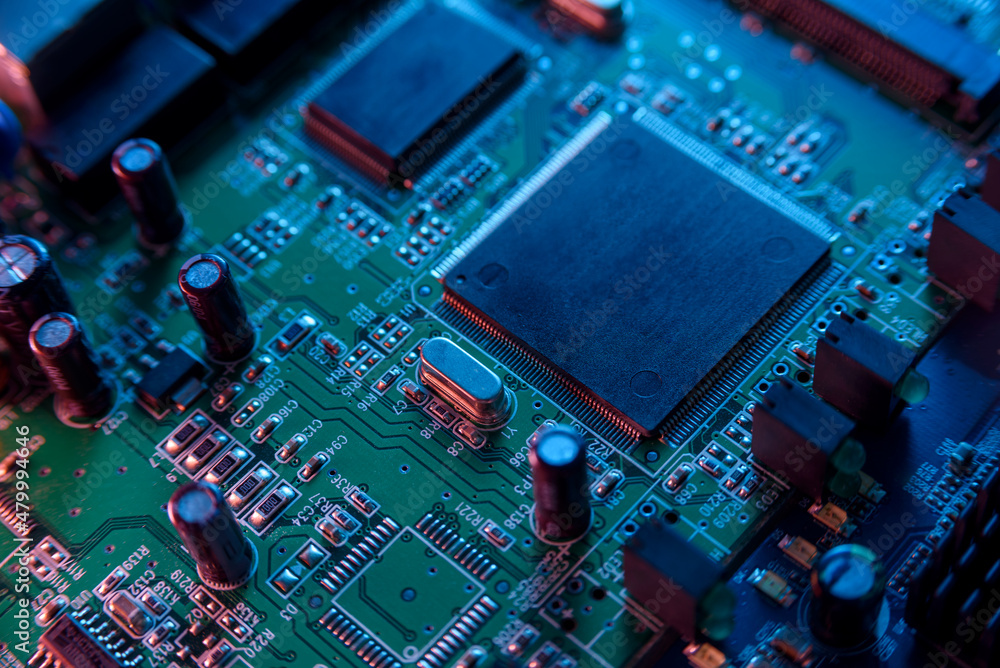 Fototapeta premium Microcircuit with chip close up with neon lighting. Chip shortage