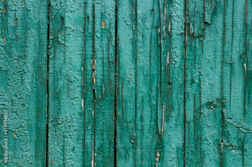 Old wooden damaged green fence as background.
