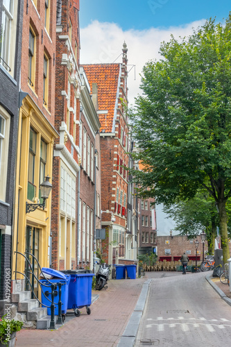 Fototapeta Naklejka Na Ścianę i Meble -  Sloping House on a Summer Street in Amsterdam