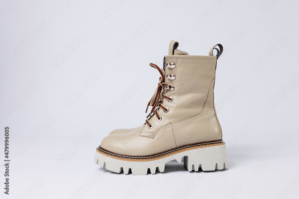 Beautiful beige shoes with genuine leather on an isolated white studio background. Fashionable classic women's boots. Stylish elegant leather shoes. Beautiful beige shoes with genuine leather on an isolated white studio background. Fashionable classic women's boots. Stylish elegant leather shoes.