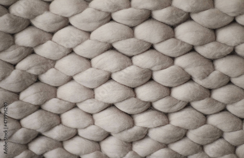 Light grey knitted background. inside of knitted woolen fabric. Neutral background of drawing	