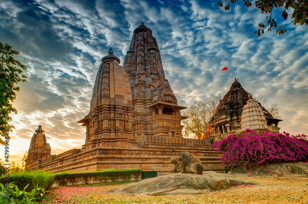 Beautiful image of Eastern Temples of Khajuraho, Madhyapradesh, India with blue sky and fluffy clouds in the background, It is worldwide famous ancient temples in India, UNESCO world heritage site.