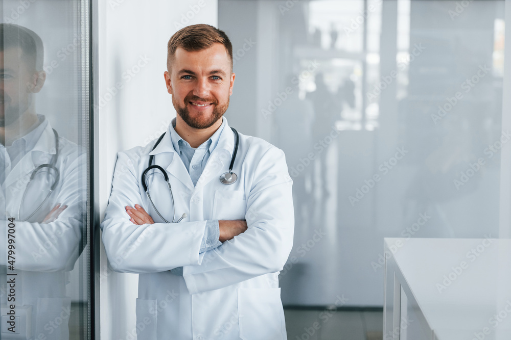 Front view. Professional medic in white coat is in the clinic Front view. Professional medic in white coat is in the clinic
