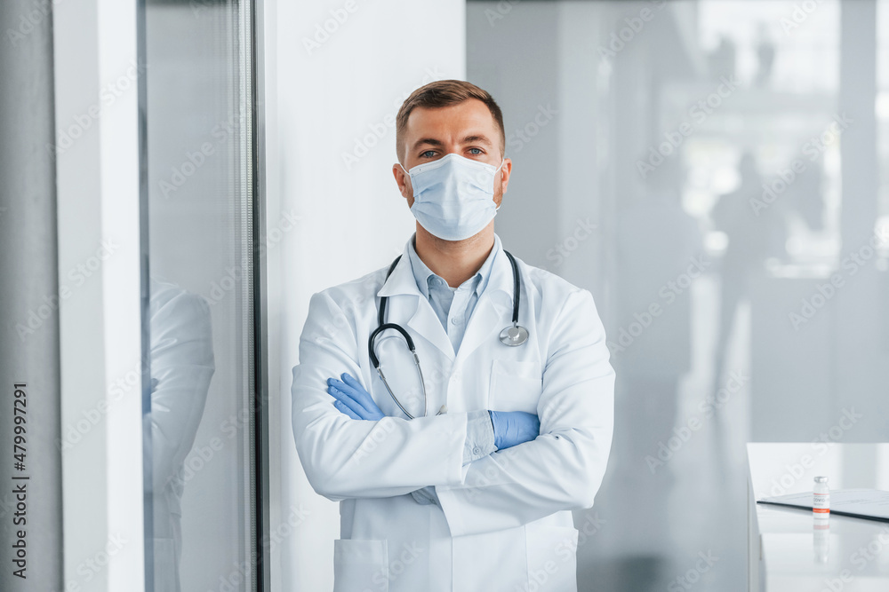 Posing for the camera. Professional medic in white coat is in the clinic Posing for the camera. Professional medic in white coat is in the clinic