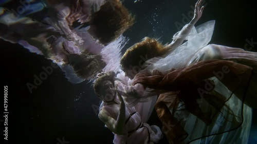 two sexy ladies swimming underwater, subaquatic shot of alluring lesbians, homosexual pair