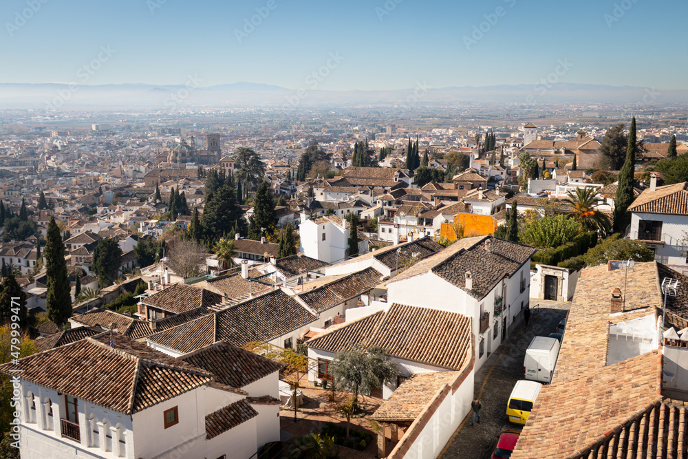 A view from Granada of the Alhambra from Paseo de los Tristes. It's a sunny day in Granada in december 2021
