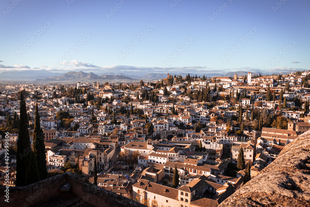 A view from Granada of the Alhambra from Paseo de los Tristes. It's a sunny day in Granada in december 2021