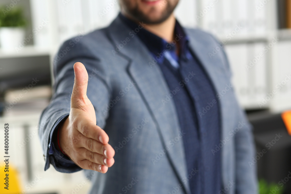 Businessman working in the office, reaching out hand forward for handshake Businessman working in the office, reaching out hand forward for handshake