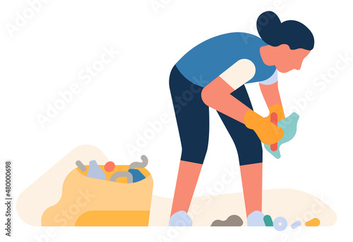 Volunteer woman collect garbage in plastic trash bag