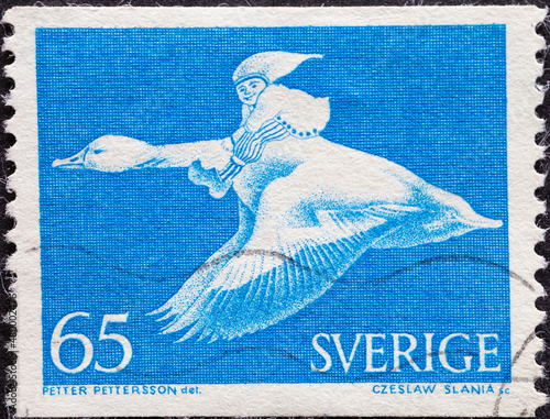 Sweden - circa 1976: a postage stamp from Sweden showing the fairy tale of Holgersson, Nils flying on the back of a wild goose photo