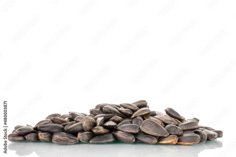 Many fragrant sunflower seeds, close-up, isolated on white. Many fragrant sunflower seeds, close-up, isolated on white.