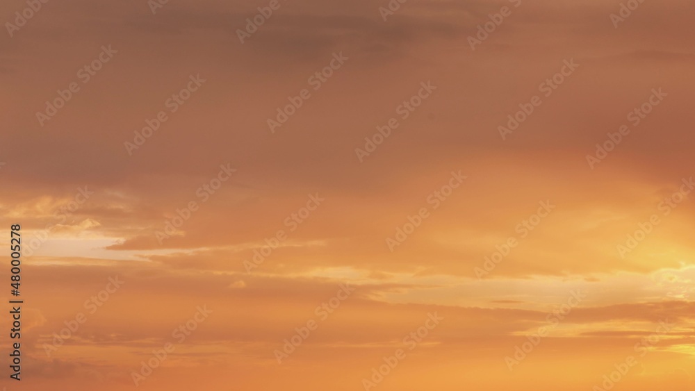 Sunset Cloudy Sky With Gently Clouds. Sunset Sky Natural Background. Sunset Time Lapse Time-Lapse In Yellow, Orange Colors. Day To Evening Transition