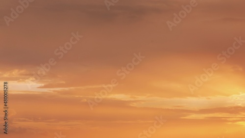 Sunset Cloudy Sky With Gently Clouds. Sunset Sky Natural Background. Sunset Time Lapse Time-Lapse In Yellow  Orange Colors. Day To Evening Transition