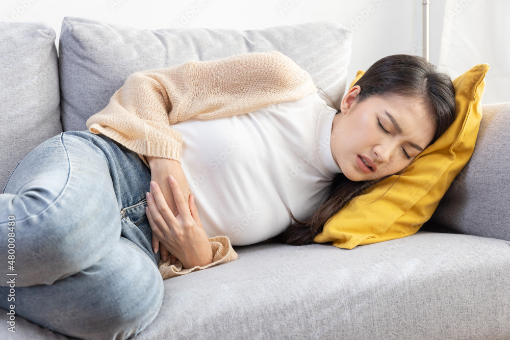 Woman Grab Her Stomach with Pain Suffer From Stomachache or Menstruation Woman Grab Her Stomach with Pain Suffer From Stomachache or Menstruation