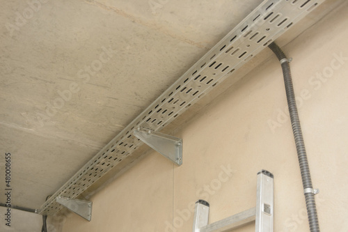 Cable route, perforated cable tray indoors. Installation of electrical equipment