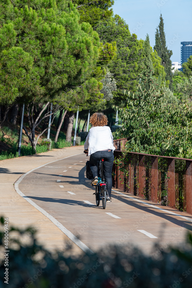 A cyclist circulating with his bicycle along the bike lane in the city of Barcelona