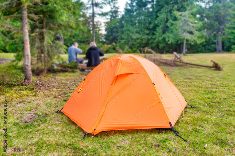 Orange tent camp in green forest Orange tent camp in green forest