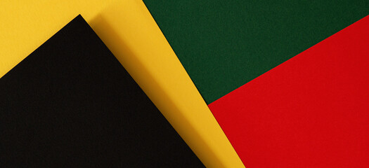 Abstract geometric black, red, yellow, green color paper background. Black History Month color background with copy space for text