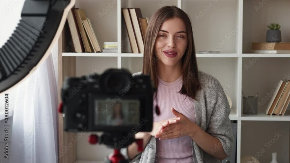 Video record. Influencer woman. Self presentation. Happy lady shooting on photo camera for personal blog sitting in light room interior. Video record. Influencer woman. Self presentation. Happy lady shooting on photo camera for personal blog sitting in light room interior.