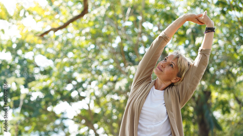 Healthy elderly woman do stretching and relaxing feel refresh and freedom in the park, healthy lifestyle and relax concept