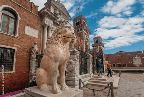 Lion sculpture at entrance of Venice Arsenal, the former shipyards complex under clouds photo