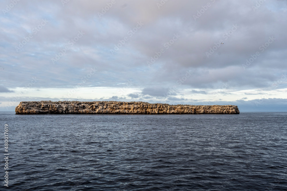 uninhabited islands of the Galapagos archipelago against the backdrop of the sea and blue sky 