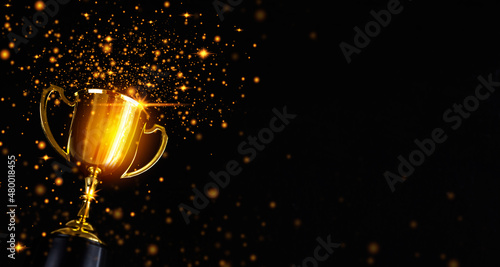 Canvas Print Champion golden trophy isolated on black background.